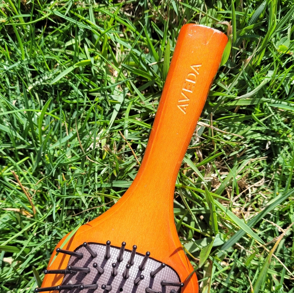 Aveda hairbrush. Wood with flexible tines.